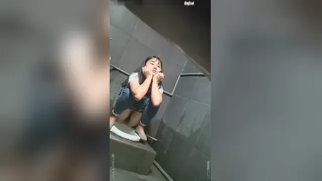 Close-up of secretly filming beautiful girls in public restrooms