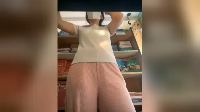 Sister reading while inserting a sex toy